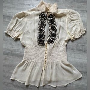 bebe Cream Puff-Sleeve Smocked Peplum Blouse with Black Floral Appliqué